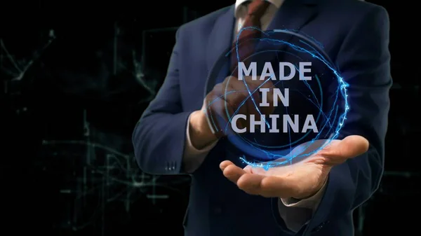 Businessman shows concept hologram Made in China on his hand — Stock Photo, Image