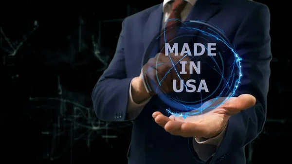 Businessman shows concept hologram Made in USA on his hand — Stock Photo, Image