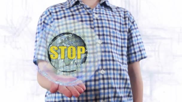 Młody człowiek pokazuje hologram planety ziemi i tekstu Stop — Wideo stockowe