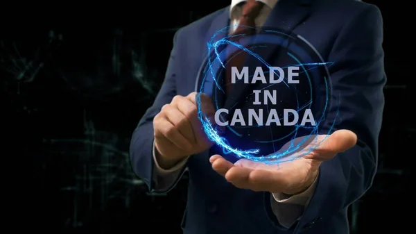 Businessman shows concept hologram Made in Canada on his hand — Stock Photo, Image