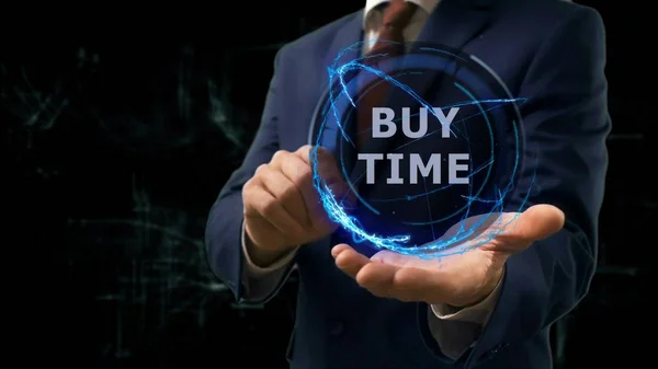 Businessman shows concept hologram Buy time on his hand — Stock Photo, Image