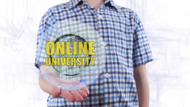 Young man shows a hologram of the planet Earth and text Online university — Stock Video