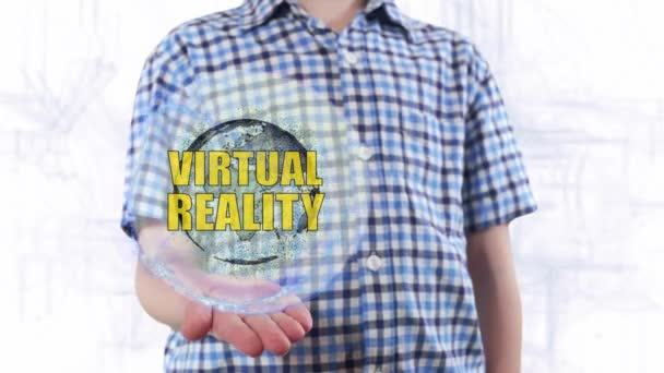 Młody człowiek pokazuje hologram planety ziemi i tekst wirtualnej rzeczywistości — Wideo stockowe