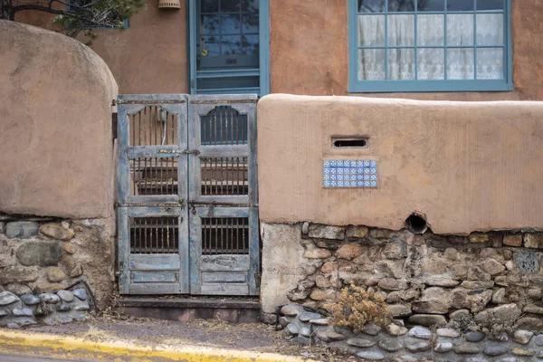 Blue gate in adobe wall