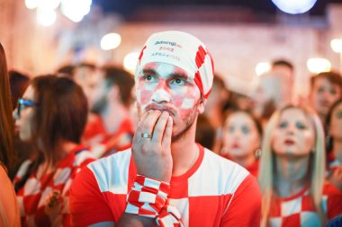 ZAGREB, CROATIA - JUNE 16TH, 2018 : Croatian football fans watching on the big screen football game of Croatia vs Nigeria on Fifa World cup 2018 on Ban Jelacic Square in Zagreb, Croatia. clipart