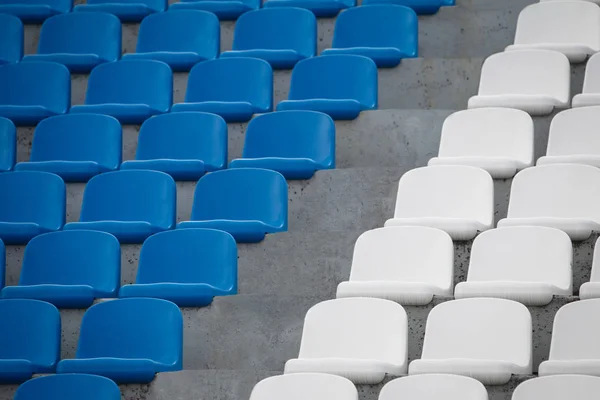 Close up of white and blue stadium seats.