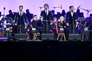 Zagreb, Croatia - December 21, 2018 : Opera trio, consisting of baritone Gianluca Ginoble (23) and two tenors Piero Barone (25) and Ignazio Boschetto (23 )Il Volo performing in Arena Zagreb in Zagreb. clipart