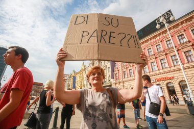 Zagreb, Croatia - 14. September, 2018 : Woman holding sign against against the ruling political party Hdz and the opposition SDP on the protest on Ban Jelacic Square in Zagreb, Croatia. clipart