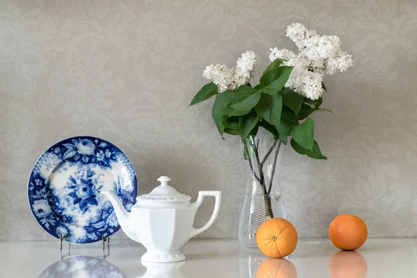 Składu Porcelany Biały Czajnik Białe Kwiaty Bzu Dwie Pomarańcze Tło — Zdjęcie stockowe