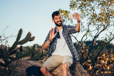 Adam selfie onun cep telefonu ile çöl yürüyüş sırasında alarak sırt çantası ile