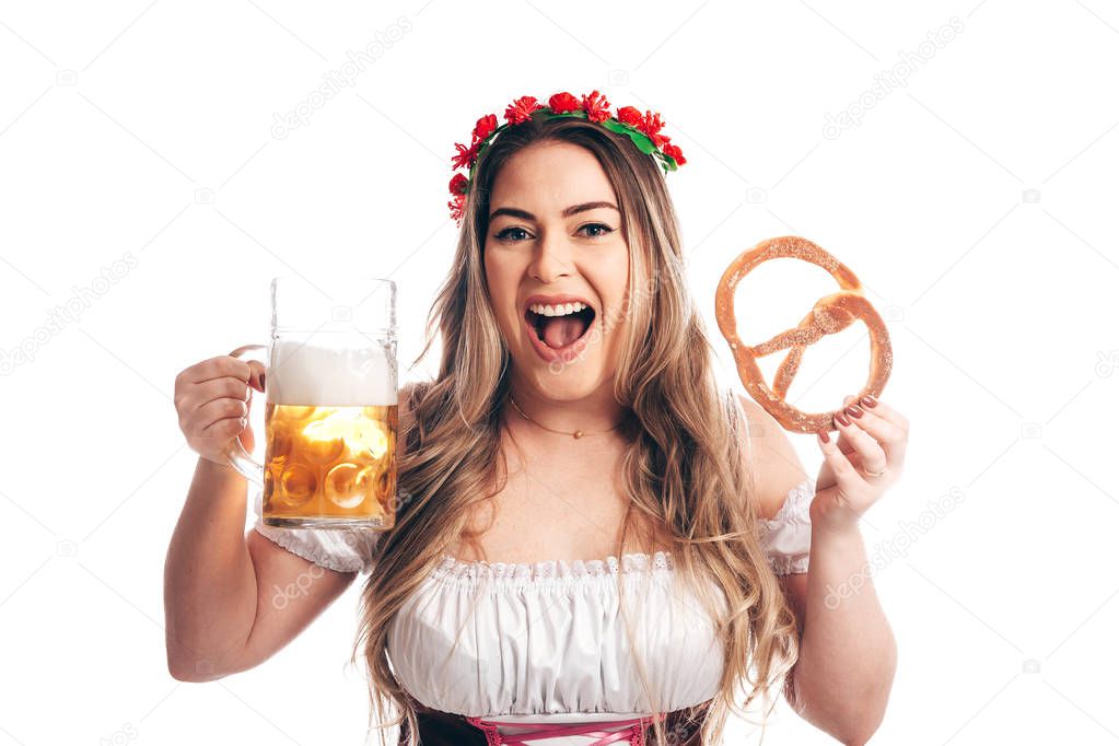 Attractive girl in traditional german costume with pretzel and beer on Oktoberfest, isolated on white