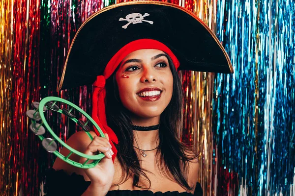 Beautiful young black woman having fun with a fake party pirate costume