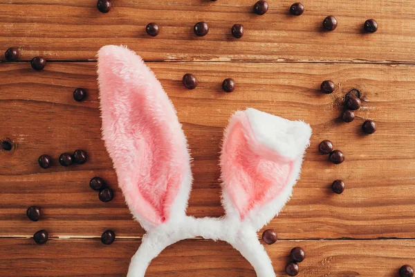 Concepto Pascua Orejas Conejo Entre Bolas Chocolate Sobre Fondo Madera —  Fotos de Stock