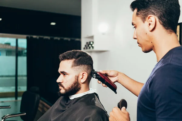 Client during beard and hair grooming in barber shop — Stock Photo, Image