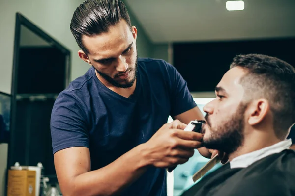 Client during beard and hair grooming in barber shop — Stock Photo, Image