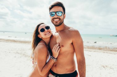 Genç çift tropik sahilde eğleniyor.
