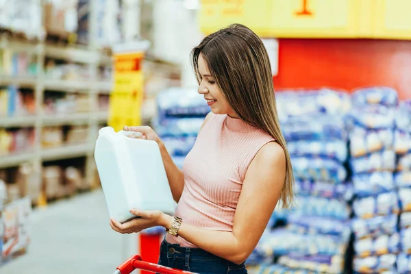 Woman choosing household products in grocery store