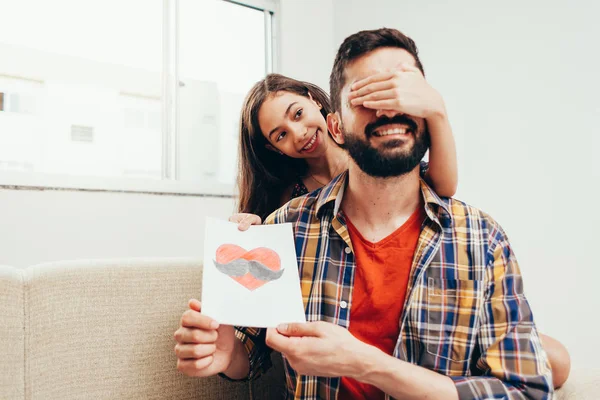 Buona festa del papà! Figlia congratularsi con papà e dargli un biglietto di auguri. Papà e figlia sorridono e si abbracciano. Vacanza in famiglia e insieme — Foto Stock