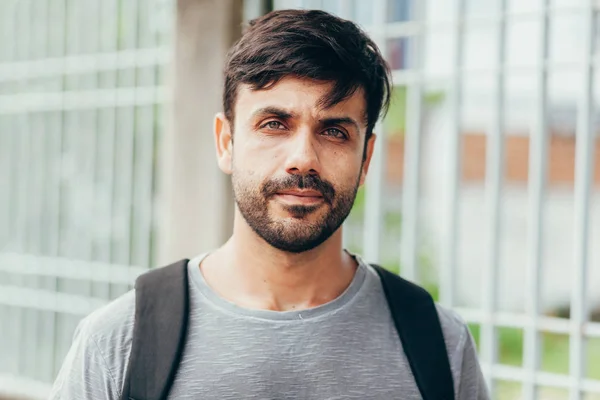 Outdoor portrait of handsome young male student with backpack — Stock Photo, Image