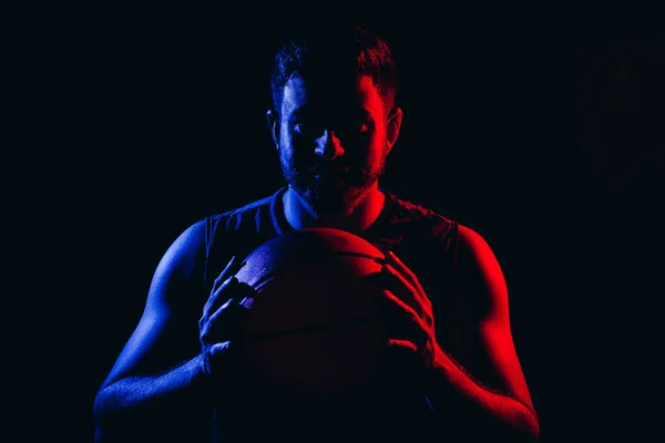 Neon light portrait of basketball player over dark background