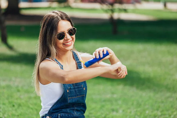 Young Woman Applying Sunscreen Insect Repellent Outdoors Public Park — Stock Photo, Image