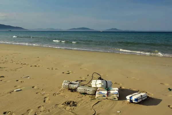 Heap of buoys. Self-made white polystyrene buoy a tied to a rope network fishing fish on a wet sand background ocean design beach fishing village. Garbage thrown ashore by waves