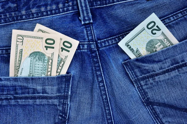 Concept math through money: 10 plus 10 equals 20. Denominations of 10 and 20 dollars in a jeans pocket