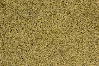 Renkli kauçuk kaplama sarı bir arka plan görüntüsü. Yıpranmış spor alan kapak