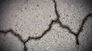 Kırık beton zemin dokusuna yakın çekim. Orijinal gri backgr