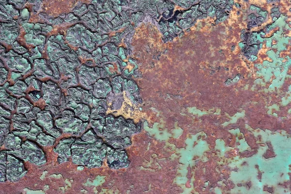 Eroded metal texture. Rusty Colored Metal with cracked paint, grunge dark green brown background