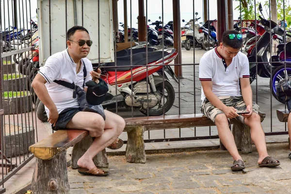 Jile 2018 Нячанг Вьетнам Два Азиата Сидят Деревянной Скамейке Смотрят — стоковое фото