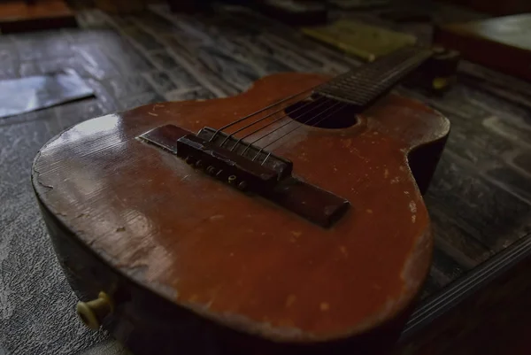 Old six-string guitar close-up. Original vintage music background