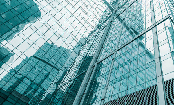 Glass facade of a modern skyscraper. reflections of neighboring buildings.