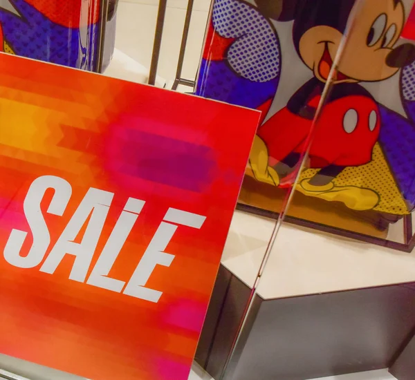 January 2, 2019. Moscow. Russia. The SALE plate on the store front next to the mickey mouse image — Stock Photo, Image