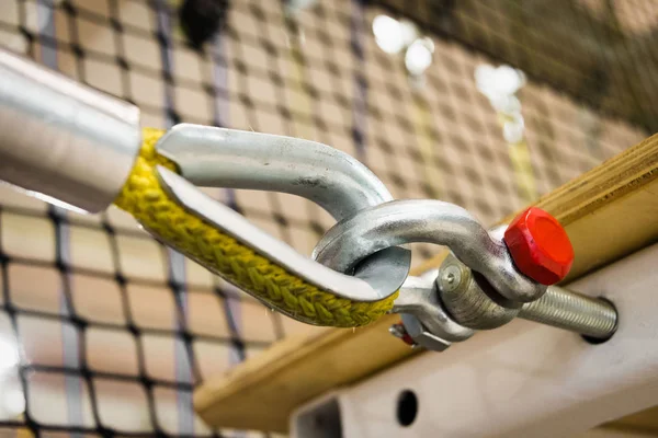 Het bevestigen van een gele nylon kabel aan een metaal structuur close-up. apparatuur in de hindernisbaan — Stockfoto