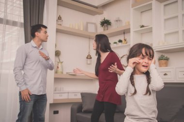 The concept of parental family quarrels, Young Couple Parents are fighting in front of children. The children are very sad to the parents quarrel. Children are crying and headaches. clipart