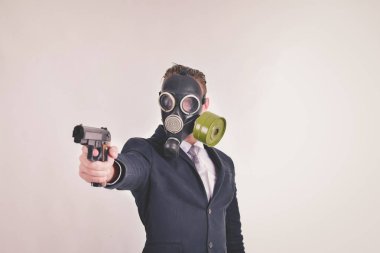İş kavramları. Beyaz bir arka plan üzerinde bir gaz maskesi giyen işadamı. İşadamları, kötü adamlar olarak gaz maskeleri giymek. İşadamları gaz kirliliği ve toksinler önlemek için maske.