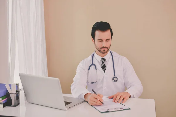 Médico Sorridente Posando Escritório Ele Está Usando Estetoscópio Equipe Médica — Fotografia de Stock