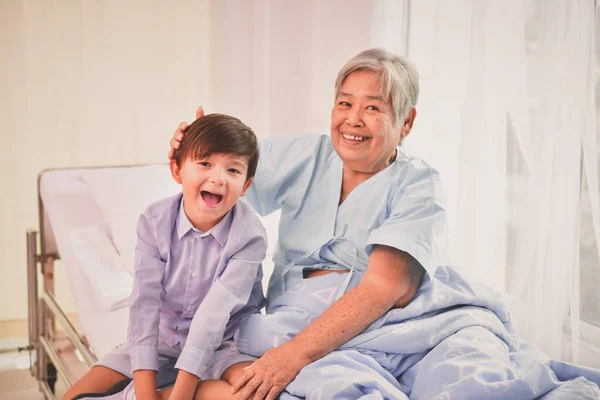 Patient Concept. Grandma\'s in the hospital. Waiting for someone to visit. Grandchildren visit grandma at the hospital. Grandma is happy to meet grandchildren.