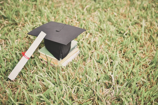 Graduation Concept. Graduated students on graduation day. Asian students are smiling happily on the graduation day. Students wear graduation gowns in the garden