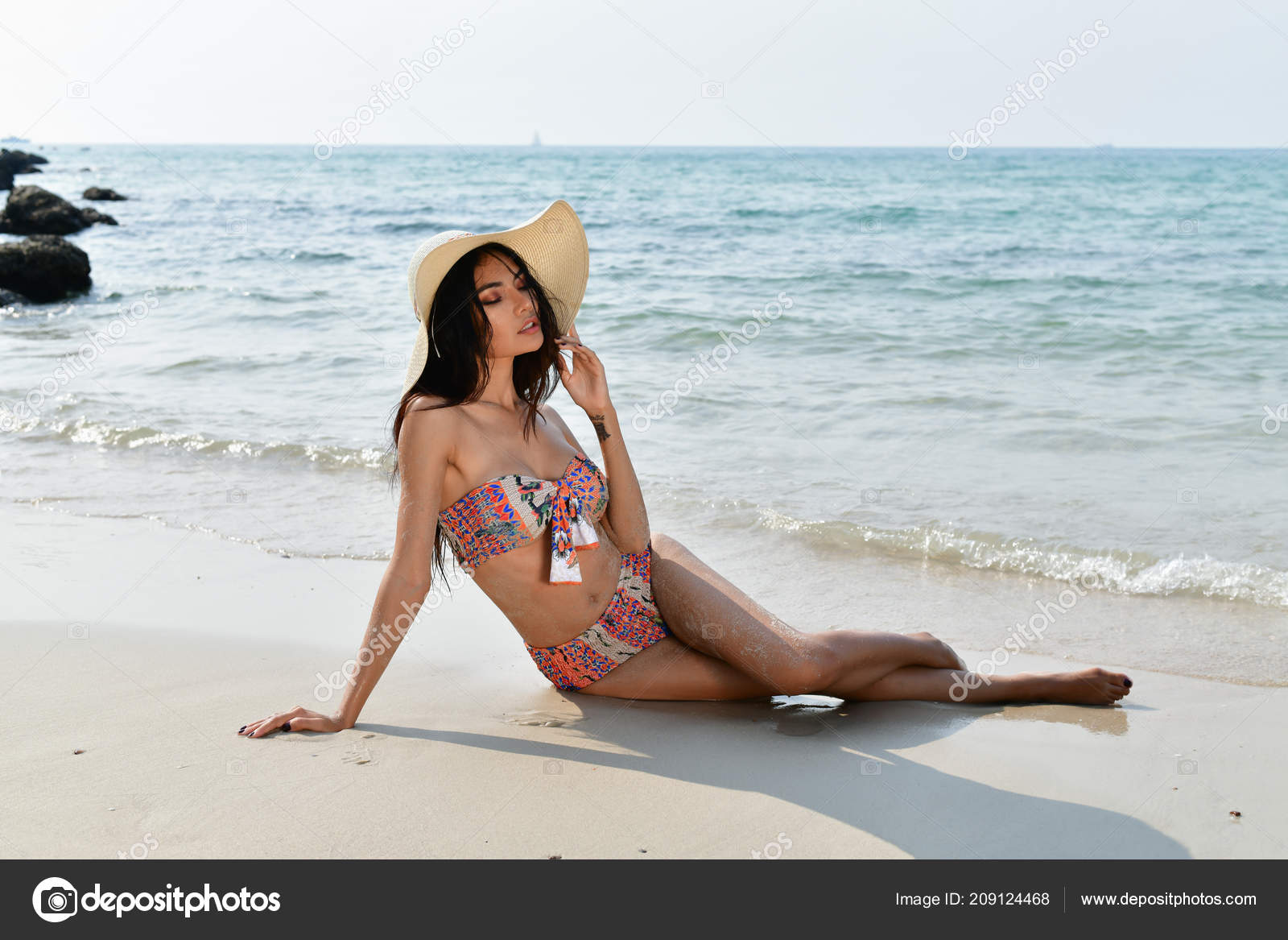Pretty woman in swimsuit poses with beach bag Stock Photo by NomadSoul1
