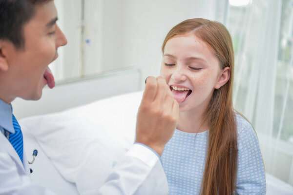 Health Concepts. The doctor is examining the health of the child. Children are happy in the hospital.