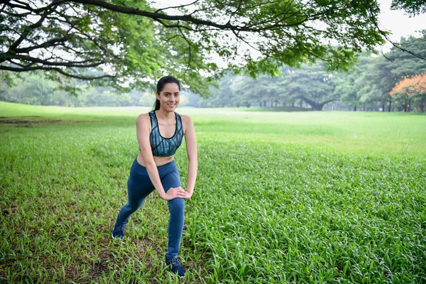 Exercise concept. Beautiful girl is stretching her muscles. Beautiful girls are warming up before running.