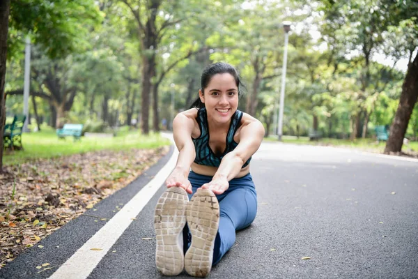 Exercise concept. Beautiful girl is stretching her muscles. Beautiful girls are warming up before running.