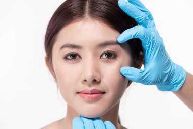 Surgery concept. Asian beautiful woman doing facial surgery. The clipart