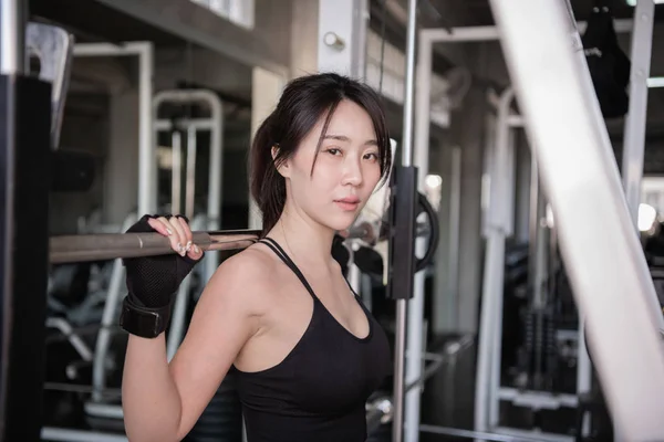 Exercise concept. A beautiful girl is exercising in the gym. Bea