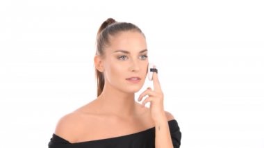 Güzellik konsepti. Kadın yüzüne toz uygulamak için sünger kullanıyor..