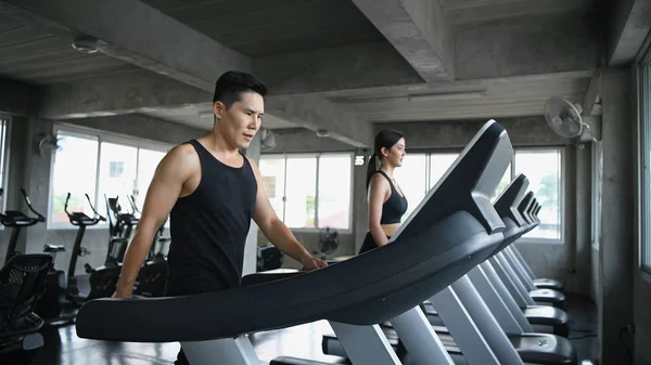 Exercise concept. Men and women are running together in the gym.