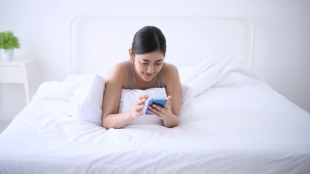 Holiday Concept Young Woman Playing Mobile Phone Bedroom — Stock Video