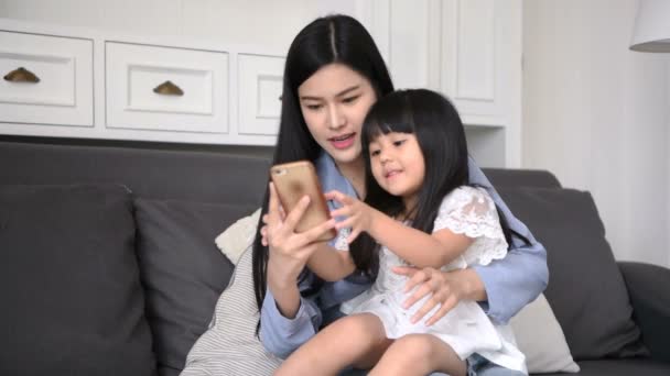 Concepto familiar. Madre e hija están tomando fotos en la sala de estar . — Vídeos de Stock